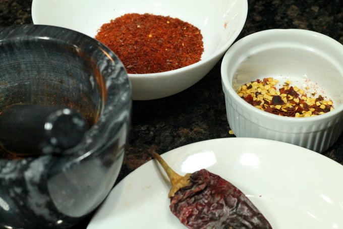 Homemade Chili powder with mortar and pestle and Pepper Flakes