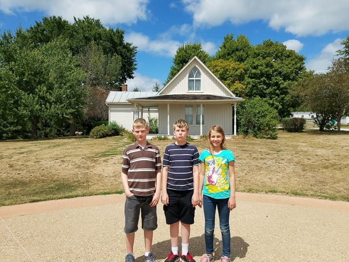 American Gothic House Kids in front of