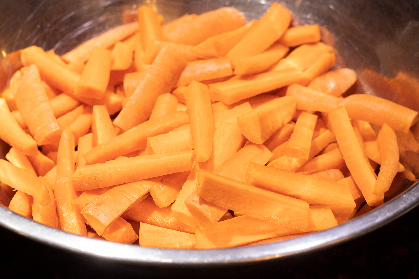 carrot sticks in metal bowl