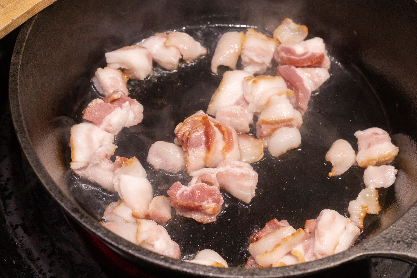 cut up bacon in a frying pan
